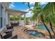 Lush backyard oasis with a covered patio, swimming pool, and tropical landscaping at 4065 Anissa Ave, Orlando, FL 32814