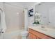 Clean bathroom featuring a shower-tub combo and a wooden vanity at 4065 Anissa Ave, Orlando, FL 32814