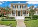 Charming two-story home with a welcoming front porch, classic columns, and beautiful landscaping at 4065 Anissa Ave, Orlando, FL 32814