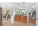 Open concept kitchen with tile flooring, wooden cabinets, and a view into the living area at 4065 Anissa Ave, Orlando, FL 32814