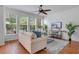 Bright living room featuring a comfortable sofa, a ceiling fan and a large window view at 4065 Anissa Ave, Orlando, FL 32814