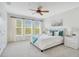 Bright main bedroom with large windows, ceiling fan, and stylish furniture at 4065 Anissa Ave, Orlando, FL 32814