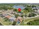 Neighborhood aerial view of the houses and a large lake. The property's location is marked with a red pin at 407 Grand Reserve Dr, Davenport, FL 33837