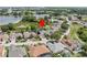 Aerial view of a home surrounded by lush greenery with a lake nearby at 407 Grand Reserve Dr, Davenport, FL 33837