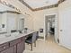 Bathroom featuring a double sink vanity with decorative trim and chair at 407 Grand Reserve Dr, Davenport, FL 33837