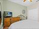 Bedroom with a wrought iron bed frame, hardwood floors, and light green walls at 407 Grand Reserve Dr, Davenport, FL 33837