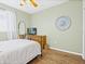 Bedroom with a wrought iron bed frame, hardwood floors, and light green walls at 407 Grand Reserve Dr, Davenport, FL 33837