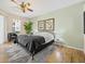 Serene bedroom with a ceiling fan, neutral tones, a plush rug, and a comfortable queen-size bed at 407 Grand Reserve Dr, Davenport, FL 33837