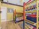 bedroom featuring colorful bunk beds, hardwood floors, and star-spangled decor at 407 Grand Reserve Dr, Davenport, FL 33837
