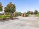 Gated community entrance featuring brick columns, mature landscaping, and secure access at 407 Grand Reserve Dr, Davenport, FL 33837
