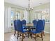 Elegant dining room with ample seating, a decorative mirror, and natural light from nearby windows at 407 Grand Reserve Dr, Davenport, FL 33837