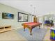 Spacious game room with a pool table, TV, and adjacent dining area, perfect for entertaining at 407 Grand Reserve Dr, Davenport, FL 33837