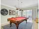 Inviting game room with a pool table, accent lighting, and access to an outdoor seating area at 407 Grand Reserve Dr, Davenport, FL 33837
