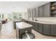 Well-equipped kitchen features gray cabinets, a functional island, and sleek appliances at 407 Grand Reserve Dr, Davenport, FL 33837