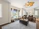 Open-concept living room filled with natural light, wood floors and access to the pool at 407 Grand Reserve Dr, Davenport, FL 33837