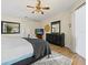 Inviting main bedroom features wood floors, a ceiling fan, and plenty of space for relaxation at 407 Grand Reserve Dr, Davenport, FL 33837