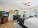 Comfortable main bedroom with wood flooring, a ceiling fan, and a dresser with TV for relaxation at 407 Grand Reserve Dr, Davenport, FL 33837