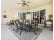 Covered patio featuring an outdoor dining area with ceiling fan and lighting at 407 Grand Reserve Dr, Davenport, FL 33837