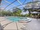Screened-in pool and spa area with ample seating for relaxation and enjoyment at 407 Grand Reserve Dr, Davenport, FL 33837