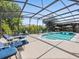 Screened-in pool and spa area with ample seating for relaxation and enjoyment at 407 Grand Reserve Dr, Davenport, FL 33837