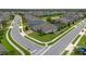 Suburban home featuring manicured lawn, mature landscaping, and paver driveway on a well-kept street at 418 Gleaming Andover Way, Longwood, FL 32779
