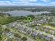 Aerial view of neighborhood homes near a lake featuring manicured landscaping, and community green spaces at 418 Gleaming Andover Way, Longwood, FL 32779