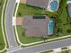 Aerial view of a home with a dark gray roof, and swimming pool, as well as manicured landscaping at 418 Gleaming Andover Way, Longwood, FL 32779