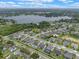 Aerial view of neighborhood homes near a lake featuring manicured landscaping, and community green spaces at 418 Gleaming Andover Way, Longwood, FL 32779