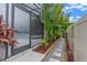 Tropical landscaped backyard with stone pathway, red rock mulch, and screened in lanai with spa at 418 Gleaming Andover Way, Longwood, FL 32779