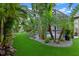 The backyard offers lush tropical landscaping creating a private screened in pool area at 418 Gleaming Andover Way, Longwood, FL 32779