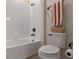 Bathroom featuring a white tub, toilet, towel rack, and tiled walls, creating a clean aesthetic at 418 Gleaming Andover Way, Longwood, FL 32779