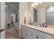 Bathroom with a dual vanity with light countertops and cabinetry with framed mirrors and modern fixtures at 418 Gleaming Andover Way, Longwood, FL 32779
