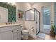 Bathroom featuring vanity, toilet, and tiled glass shower with access to the outdoors at 418 Gleaming Andover Way, Longwood, FL 32779
