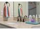 Close-up of bathroom vanity featuring modern fixtures, neutral countertops, and decorative accessories at 418 Gleaming Andover Way, Longwood, FL 32779