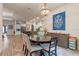 Dining room showcasing an open-concept design with a stylish chandelier and modern decor at 418 Gleaming Andover Way, Longwood, FL 32779