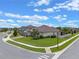 Well-maintained home featuring a manicured lawn, mature landscaping, and paver driveway on a corner lot at 418 Gleaming Andover Way, Longwood, FL 32779