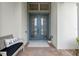 Inviting front entrance featuring a double door with decorative glass and charming bench at 418 Gleaming Andover Way, Longwood, FL 32779