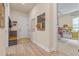Hallway with wood floors, a bench, and entryway storage, seamlessly transitioning to another room at 418 Gleaming Andover Way, Longwood, FL 32779