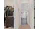 Hallway leading to a bathroom, with a closet/storage on the left and closet on the right at 418 Gleaming Andover Way, Longwood, FL 32779