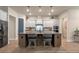 Kitchen with large island, bar seating, stainless appliances, stylish pendant lights, and tiled backsplash at 418 Gleaming Andover Way, Longwood, FL 32779