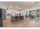 Bright kitchen with a large island, modern appliances, pendant lighting, and open access to dining area at 418 Gleaming Andover Way, Longwood, FL 32779