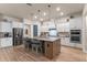 Well-lit kitchen features an island with seating, stainless steel appliances, and decorative backsplash at 418 Gleaming Andover Way, Longwood, FL 32779