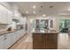 Modern kitchen featuring white cabinetry, stainless steel appliances, large island, and wood floors at 418 Gleaming Andover Way, Longwood, FL 32779