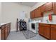 Laundry room featuring ample cabinet space, a utility sink, and washer and dryer at 418 Gleaming Andover Way, Longwood, FL 32779