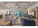 Open-concept living room with pool view, comfortable seating, and stylish decor throughout the space at 418 Gleaming Andover Way, Longwood, FL 32779
