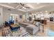 Spacious living room features a coffered ceiling, stylish furniture, and an open layout to the kitchen at 418 Gleaming Andover Way, Longwood, FL 32779