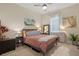 Cozy main bedroom with ceiling fan, soft lighting, and neutral color scheme at 418 Gleaming Andover Way, Longwood, FL 32779