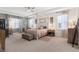 Spacious primary suite featuring a tray ceiling, sitting area, and a four-poster bed at 418 Gleaming Andover Way, Longwood, FL 32779