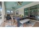 Covered outdoor patio featuring a dining table, seating area, and stylish decor for relaxed living at 418 Gleaming Andover Way, Longwood, FL 32779