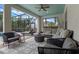 Relaxing screened-in patio with plush seating, ceiling fan, and views of the pool and lush tropical landscaping at 418 Gleaming Andover Way, Longwood, FL 32779